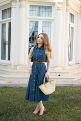 a lady wears a midi denim dress with a leather belt